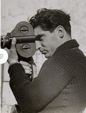 Filmmaker looking through 16mm film camera