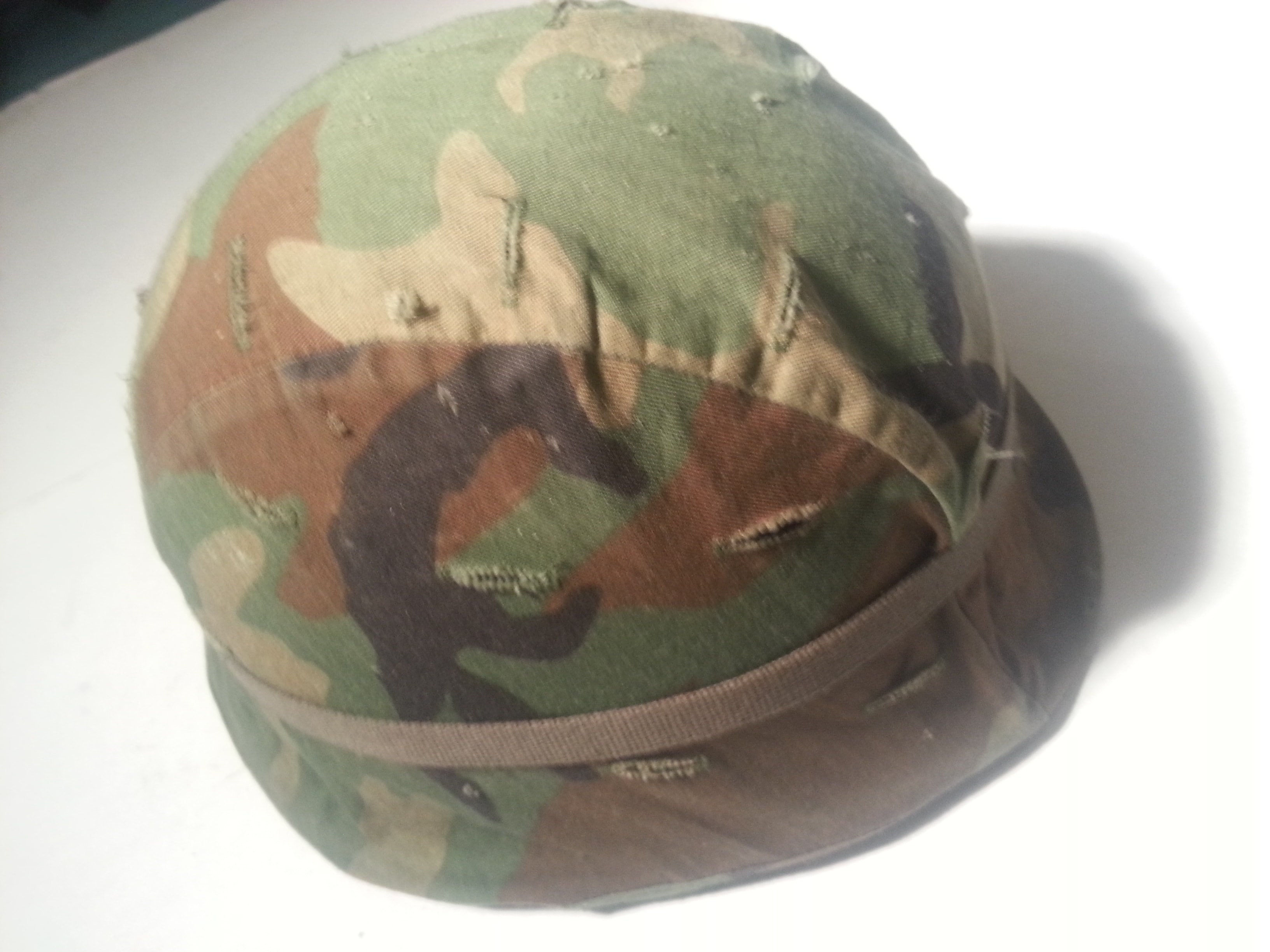 Vietnam era M1 combat helmet with camouflage cover