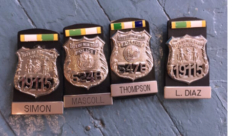 Four NYPD reproduction movie badges — Simon, Mascoll, Thompson, L. Diaz — with ribbon bars, prop badges for film and TV